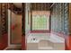 Full bathroom showcasing floral wallpaper, a soaking tub, and a glass enclosed shower stall at 4531 Cedar Dr, Loganville, GA 30052