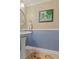 Powder room featuring a pedestal sink, wainscoting, and a decorative mirror at 4531 Cedar Dr, Loganville, GA 30052