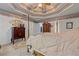 Comfortable bedroom featuring a four-poster bed, neutral wall colors, and a tray ceiling with floral border at 4531 Cedar Dr, Loganville, GA 30052