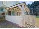 Covered back deck featuring white railing and posts, a ceiling fan, and gated access to the yard at 4531 Cedar Dr, Loganville, GA 30052