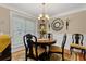 Charming dining area with a round table, chandelier, and decorative wall mirror at 4531 Cedar Dr, Loganville, GA 30052