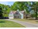 Beautiful light-blue home with red shutters and a two-car garage situated on a large lot at 4531 Cedar Dr, Loganville, GA 30052
