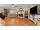 Spacious living room with hardwood floors, a cozy fireplace, and built-in shelving for decor at 4531 Cedar Dr, Loganville, GA 30052