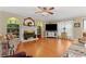 Cozy living room with a fireplace, hardwood floors, and large windows offering natural light at 4531 Cedar Dr, Loganville, GA 30052