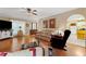 Bright living room featuring hardwood floors, comfortable seating, and a seamless flow to other living spaces at 4531 Cedar Dr, Loganville, GA 30052