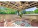 Relaxing covered patio with an outdoor table, seating, and a ceiling fan, perfect for outdoor enjoyment at 4531 Cedar Dr, Loganville, GA 30052