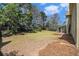 Expansive backyard with mature trees, screened patio, and a natural landscape at 5222 Camden Lake Nw Pkwy, Acworth, GA 30101