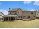 Large backyard with a covered patio, spacious lawn, and mature trees at 5222 Camden Lake Nw Pkwy, Acworth, GA 30101