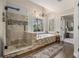 Luxurious bathroom featuring a glass shower, soaking tub, and elegant chandelier at 5222 Camden Lake Nw Pkwy, Acworth, GA 30101