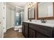 Modern bathroom with dual vanities, stylish mirrors, and a separate glass-enclosed shower at 5222 Camden Lake Nw Pkwy, Acworth, GA 30101