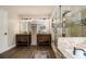 Luxurious main bathroom with a walk-in shower, soaking tub, and dual vanities at 5222 Camden Lake Nw Pkwy, Acworth, GA 30101