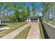 Backyard view of detached garage and extra parking space with lawn at 917 Derrydown Way, Decatur, GA 30030