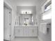 A bathroom with a double sink vanity, large mirror, and updated fixtures at 917 Derrydown Way, Decatur, GA 30030
