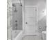 Well-lit bathroom featuring a shower-tub combination and modern fixtures at 917 Derrydown Way, Decatur, GA 30030