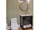 Charming powder room features patterned wallpaper and a black vanity with storage at 917 Derrydown Way, Decatur, GA 30030