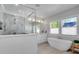 Modern bathroom featuring a glass-enclosed shower, soaking tub, double vanity, and ample natural light at 917 Derrydown Way, Decatur, GA 30030