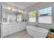 A luxurious bathroom showcasing a soaking tub, dual vanities, and bright windows at 917 Derrydown Way, Decatur, GA 30030