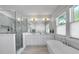 A contemporary bathroom with a soaking tub, glass shower, and bright double vanity at 917 Derrydown Way, Decatur, GA 30030