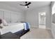 A bright bedroom with neutral tones featuring a ceiling fan, closet, and ensuite bathroom at 917 Derrydown Way, Decatur, GA 30030