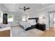 A bright bedroom features a ceiling fan, and a comfortable king-size bed with a grey upholstered headboard at 917 Derrydown Way, Decatur, GA 30030