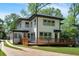 Charming home featuring a new white exterior, modern windows and a spacious deck at 917 Derrydown Way, Decatur, GA 30030