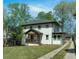 Charming two-story home featuring a white facade, dark trim, and a well-manicured front lawn at 917 Derrydown Way, Decatur, GA 30030