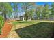 View of the detached garage, lush lawn and privacy fence at 917 Derrydown Way, Decatur, GA 30030