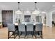 Spacious kitchen boasts a large island with seating, stainless steel appliances, and modern pendant lighting at 917 Derrydown Way, Decatur, GA 30030