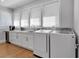 Bright laundry room with white cabinets, countertops, and modern washer and dryer at 917 Derrydown Way, Decatur, GA 30030
