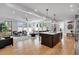 Open concept living area showcasing hardwood floors, a center island, and a seamless flow between kitchen and living spaces at 917 Derrydown Way, Decatur, GA 30030