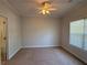 Carpeted bedroom with a ceiling fan and natural light from a window at 2575 Rosehill Circle, Lithia Springs, GA 30122