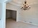 Dining room featuring carpet floors, a chandelier, wainscoting, and a large window at 2575 Rosehill Circle, Lithia Springs, GA 30122