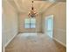 Dining room featuring carpet floors, a chandelier, wainscoting, and a large window at 2575 Rosehill Circle, Lithia Springs, GA 30122
