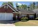 Charming brick home with a well-maintained lawn, attached garage, and a cozy front entrance at 2575 Rosehill Circle, Lithia Springs, GA 30122