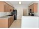 Kitchen featuring wooden cabinets, light countertops, tile floors, and black appliances at 2575 Rosehill Circle, Lithia Springs, GA 30122