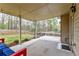 Covered back porch with outdoor seating and string lights overlooking the grassy backyard and wood fence at 8045 Hillside Climb Way, Snellville, GA 30039