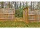 Wooden fence with gate leading to wooded area at 8045 Hillside Climb Way, Snellville, GA 30039