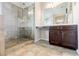 Bathroom boasts tiled walk-in shower, dark cabinetry and neutral tile floors at 8045 Hillside Climb Way, Snellville, GA 30039