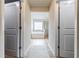 Bright bathroom hallway leading to a tub and shower with neutral paint colors at 8045 Hillside Climb Way, Snellville, GA 30039