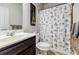 Bathroom with dark wood vanity and Eiffel tower shower curtain at 8045 Hillside Climb Way, Snellville, GA 30039