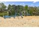 Sandy beach area with picnic tables, playground equipment, and access to the water at 8045 Hillside Climb Way, Snellville, GA 30039