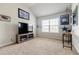 This bedroom offers neutral walls and carpeting, plus a large window for natural light at 8045 Hillside Climb Way, Snellville, GA 30039