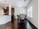 Bright dining area with hardwood floors, a large clock, and a view into the kitchen, perfect for Gathering meals at 8045 Hillside Climb Way, Snellville, GA 30039