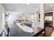 Open-concept dining area leading to a living room and modern kitchen with a large dining table set at 8045 Hillside Climb Way, Snellville, GA 30039