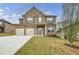 Inviting two-story brick home showcasing a two-car garage and well-manicured front lawn at 8045 Hillside Climb Way, Snellville, GA 30039