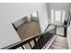 View from the second floor looking down to the foyer with a white front door and wood floors at 8045 Hillside Climb Way, Snellville, GA 30039