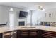 Kitchen with stainless steel dishwasher, granite countertops, dark wood cabinets, and hardwood flooring at 8045 Hillside Climb Way, Snellville, GA 30039