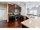 Modern kitchen featuring dark wood cabinets, stainless steel appliances, granite countertops, and hardwood floors at 8045 Hillside Climb Way, Snellville, GA 30039