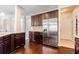 Contemporary kitchen with stainless steel appliances, dark cabinets, granite countertops, and hardwood flooring at 8045 Hillside Climb Way, Snellville, GA 30039