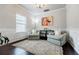 Bright living room with hardwood floors, a decorative rug, and two comfortable chairs at 8045 Hillside Climb Way, Snellville, GA 30039